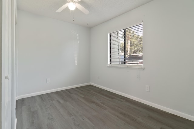 spare room with ceiling fan, dark wood-type flooring, and a textured ceiling