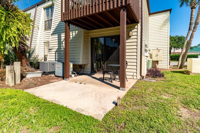 back of house featuring a yard, central AC, a patio area, and a wooden deck