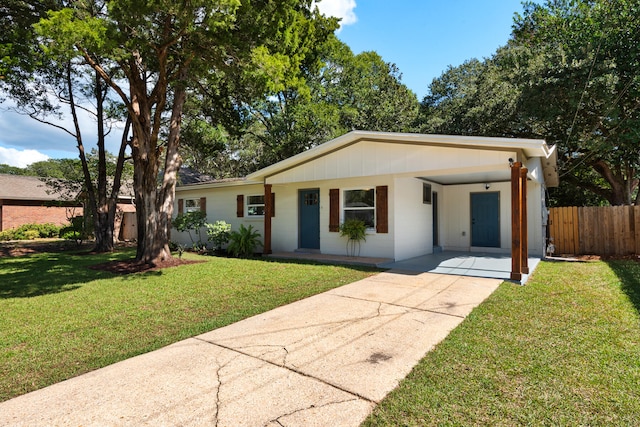 ranch-style home with a carport and a front lawn