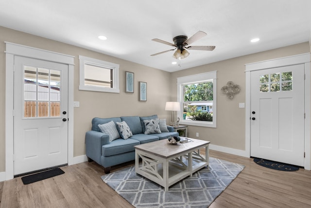 living room with ceiling fan and light hardwood / wood-style floors