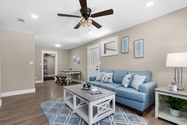 living room with ceiling fan and dark hardwood / wood-style flooring