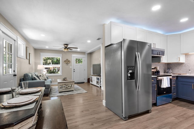 kitchen featuring blue cabinetry, white cabinetry, ceiling fan, light hardwood / wood-style floors, and appliances with stainless steel finishes