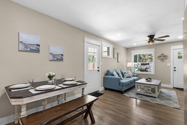 living room featuring dark hardwood / wood-style flooring and ceiling fan