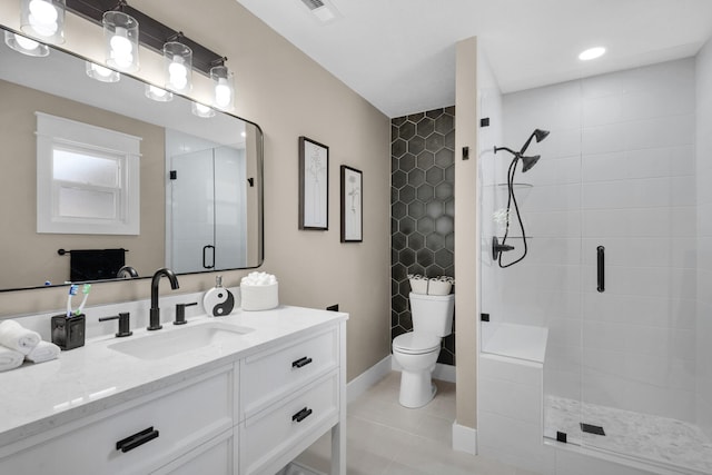 bathroom featuring tile patterned flooring, vanity, toilet, and walk in shower