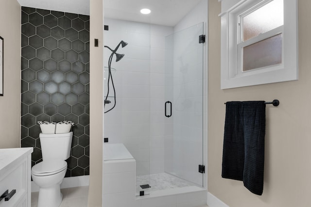 bathroom featuring vanity, tile patterned floors, toilet, tile walls, and walk in shower