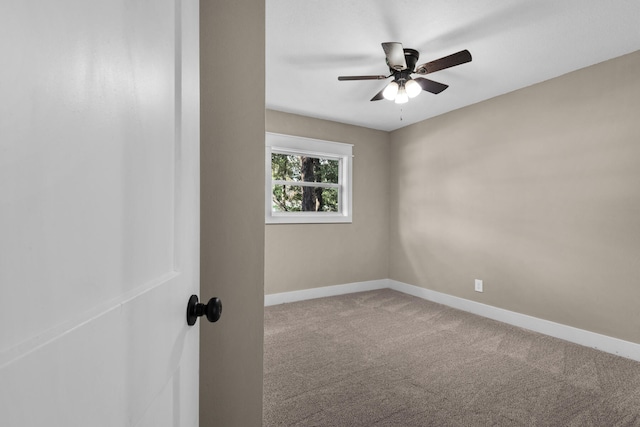 unfurnished room with ceiling fan and carpet