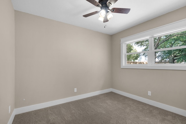 carpeted empty room featuring ceiling fan