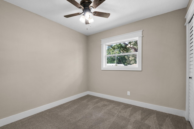 carpeted spare room featuring ceiling fan