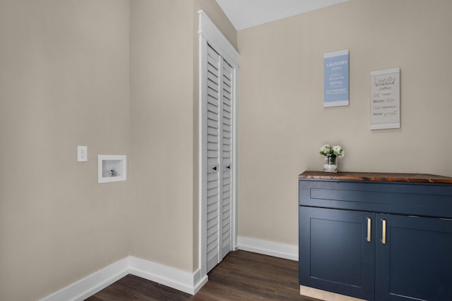 laundry room with dark hardwood / wood-style flooring, hookup for a washing machine, and cabinets