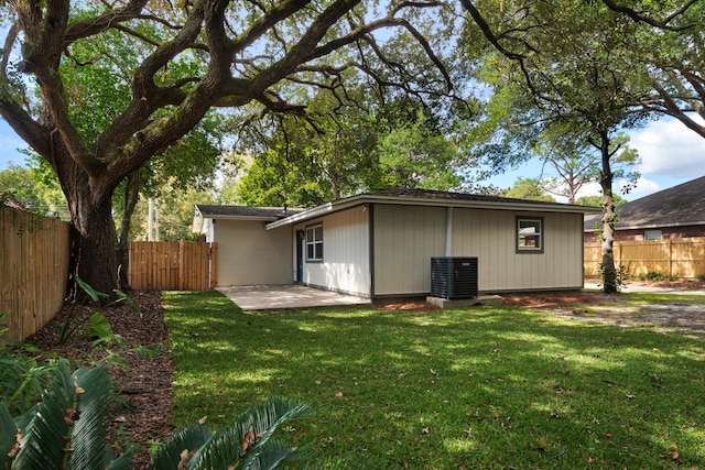 back of property with a yard, central AC, and a patio area