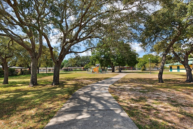 view of community featuring a lawn and a playground