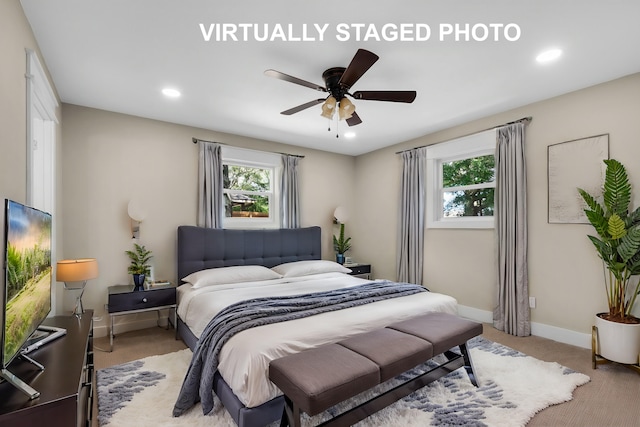 bedroom featuring ceiling fan and light carpet