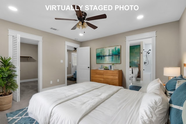 carpeted bedroom with ensuite bathroom, ceiling fan, a walk in closet, and a closet