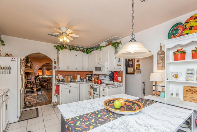 kitchen with hanging light fixtures, white appliances, ceiling fan, and white cabinets