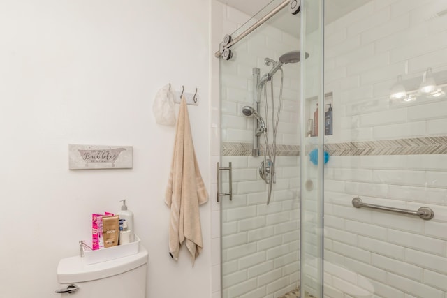 bathroom featuring toilet and an enclosed shower