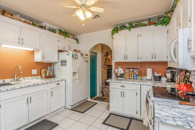 kitchen featuring white appliances, ceiling fan, white cabinetry, and sink