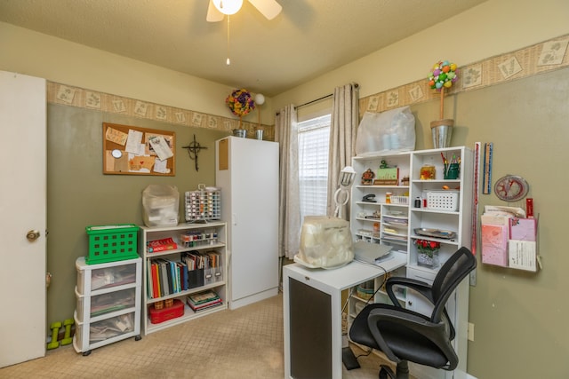 carpeted home office with ceiling fan and a textured ceiling