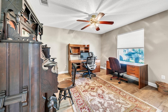 office area with ceiling fan, a textured ceiling, and light hardwood / wood-style flooring