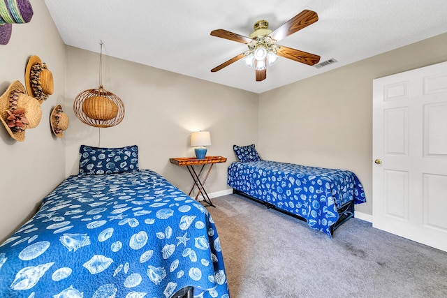 bedroom with carpet floors, a textured ceiling, and ceiling fan