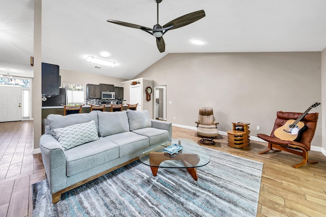 living room featuring light wood-type flooring, lofted ceiling, and ceiling fan