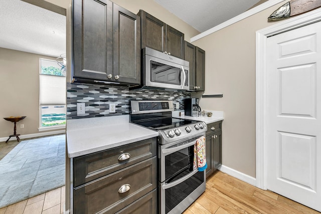 kitchen featuring backsplash, stainless steel appliances, light wood-type flooring, a textured ceiling, and dark brown cabinets