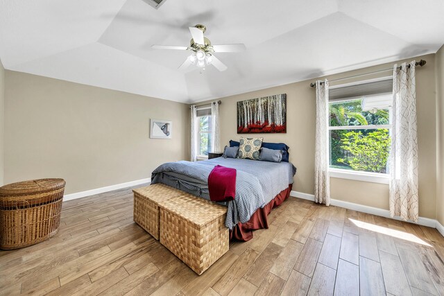 bedroom featuring ceiling fan, vaulted ceiling, and light hardwood / wood-style floors