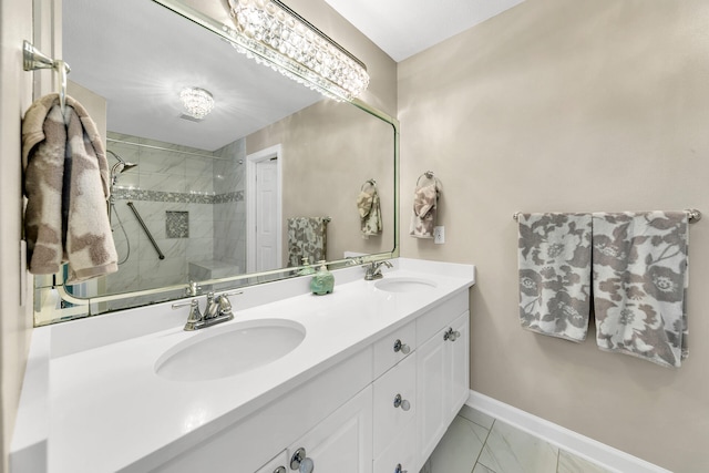 bathroom with a tile shower and vanity