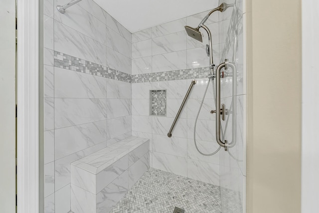 bathroom with a tile shower