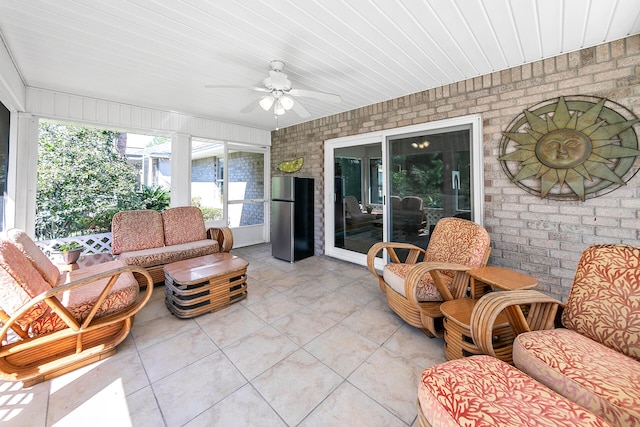 sunroom featuring ceiling fan and wood ceiling