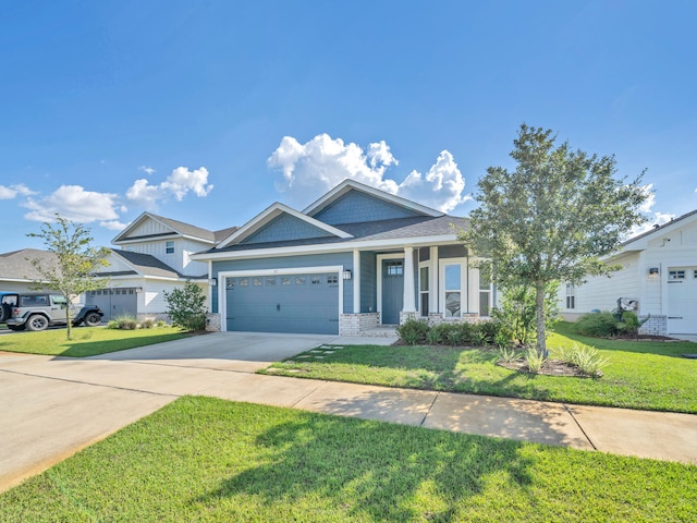 view of front of property with a front yard and a garage