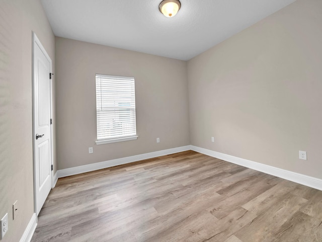 spare room with light hardwood / wood-style floors