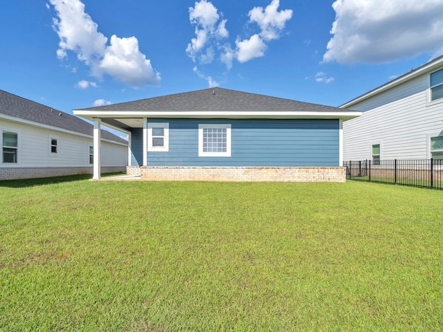 rear view of house with a lawn