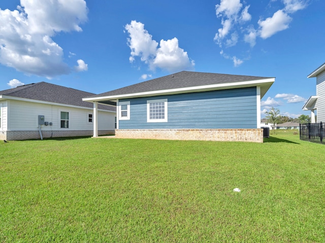 rear view of property featuring a yard