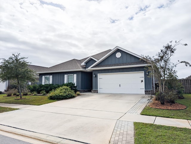 view of front of house featuring a front yard and a garage