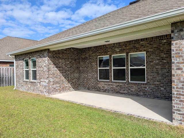 rear view of property with a yard and a patio area