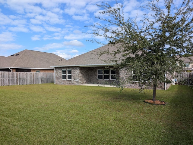 back of house featuring a lawn