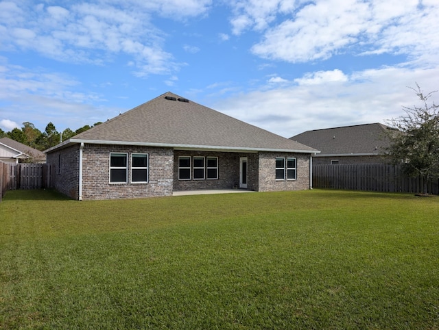 back of house with a lawn