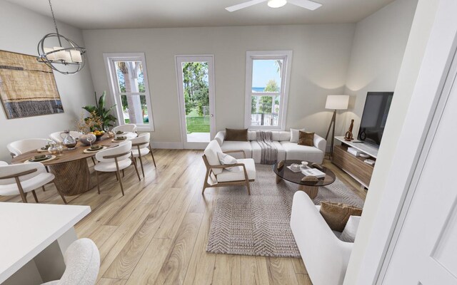 living room with ceiling fan with notable chandelier and light wood-type flooring