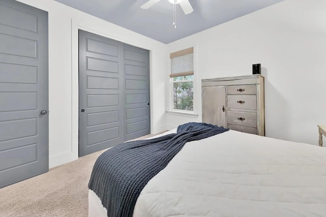 bedroom with carpet floors, ceiling fan, and a closet