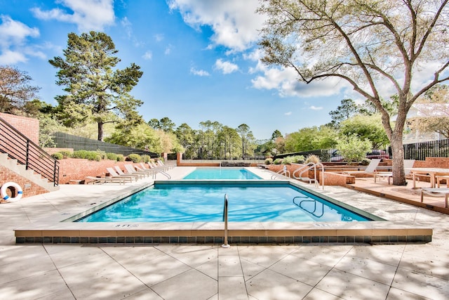 view of swimming pool with a patio area