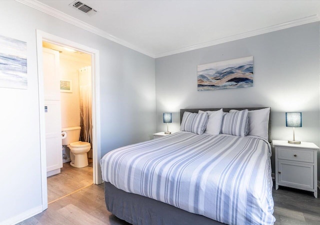 bedroom with light hardwood / wood-style flooring, connected bathroom, and ornamental molding