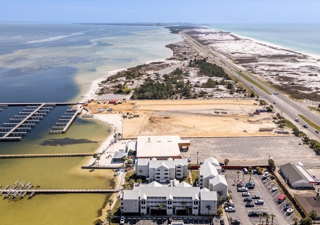 drone / aerial view with a beach view and a water view