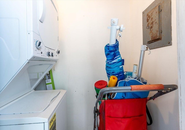 clothes washing area with stacked washer / dryer