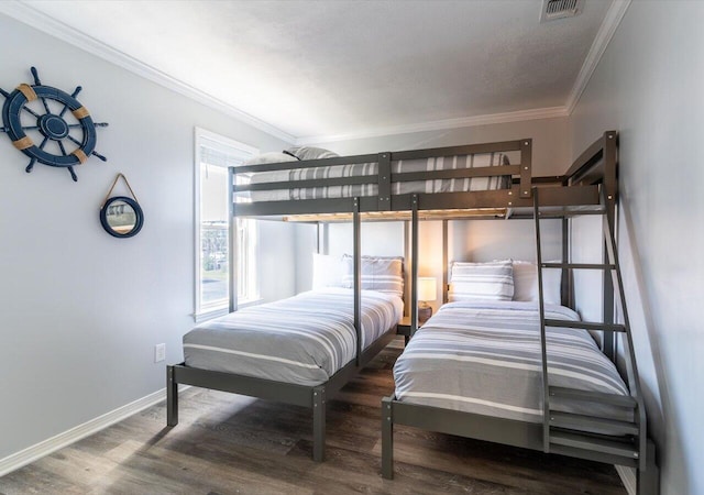 bedroom featuring ornamental molding and dark wood-type flooring