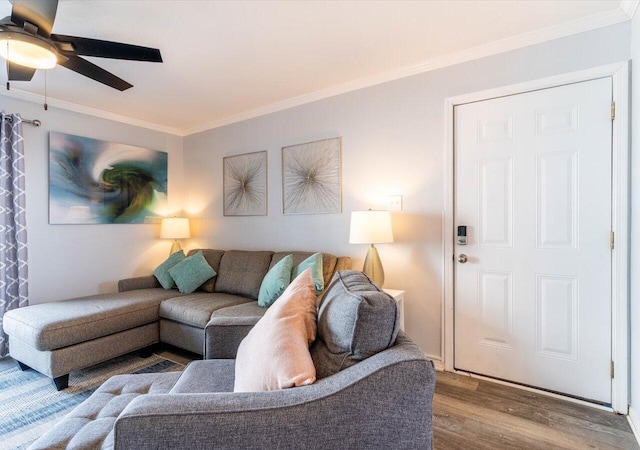 living room featuring wood-type flooring, crown molding, and ceiling fan