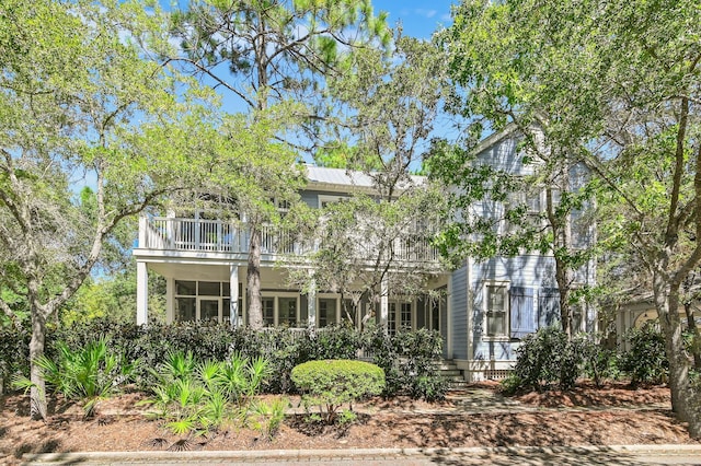 view of front of house featuring a balcony