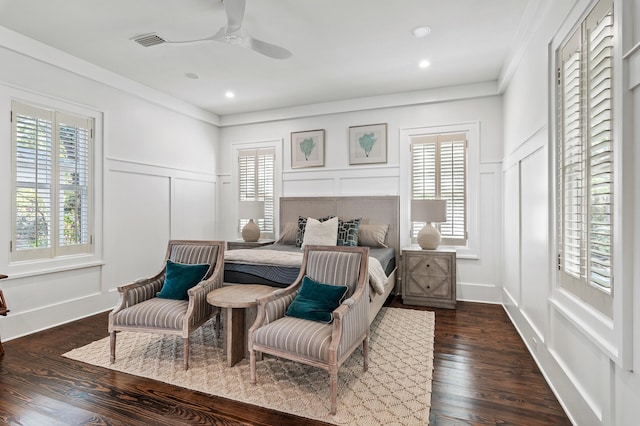 bedroom with ornamental molding, ceiling fan, and dark wood-type flooring