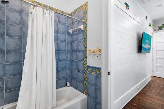 bathroom featuring hardwood / wood-style floors and shower / tub combo with curtain