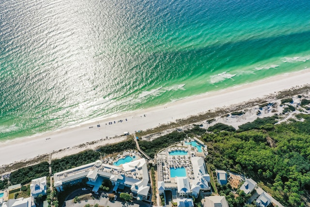 drone / aerial view with a water view and a beach view