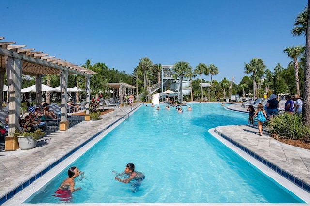 view of pool with a pergola, a water slide, and a patio